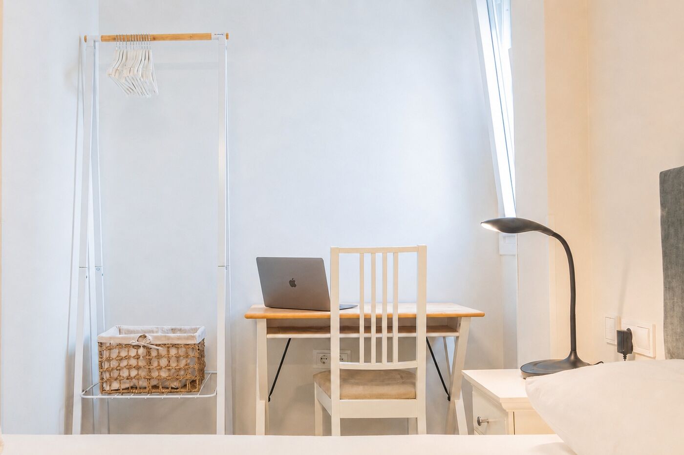 Bedroom desk with chair, lamp and open laptop beside a window at Casa del Castillo